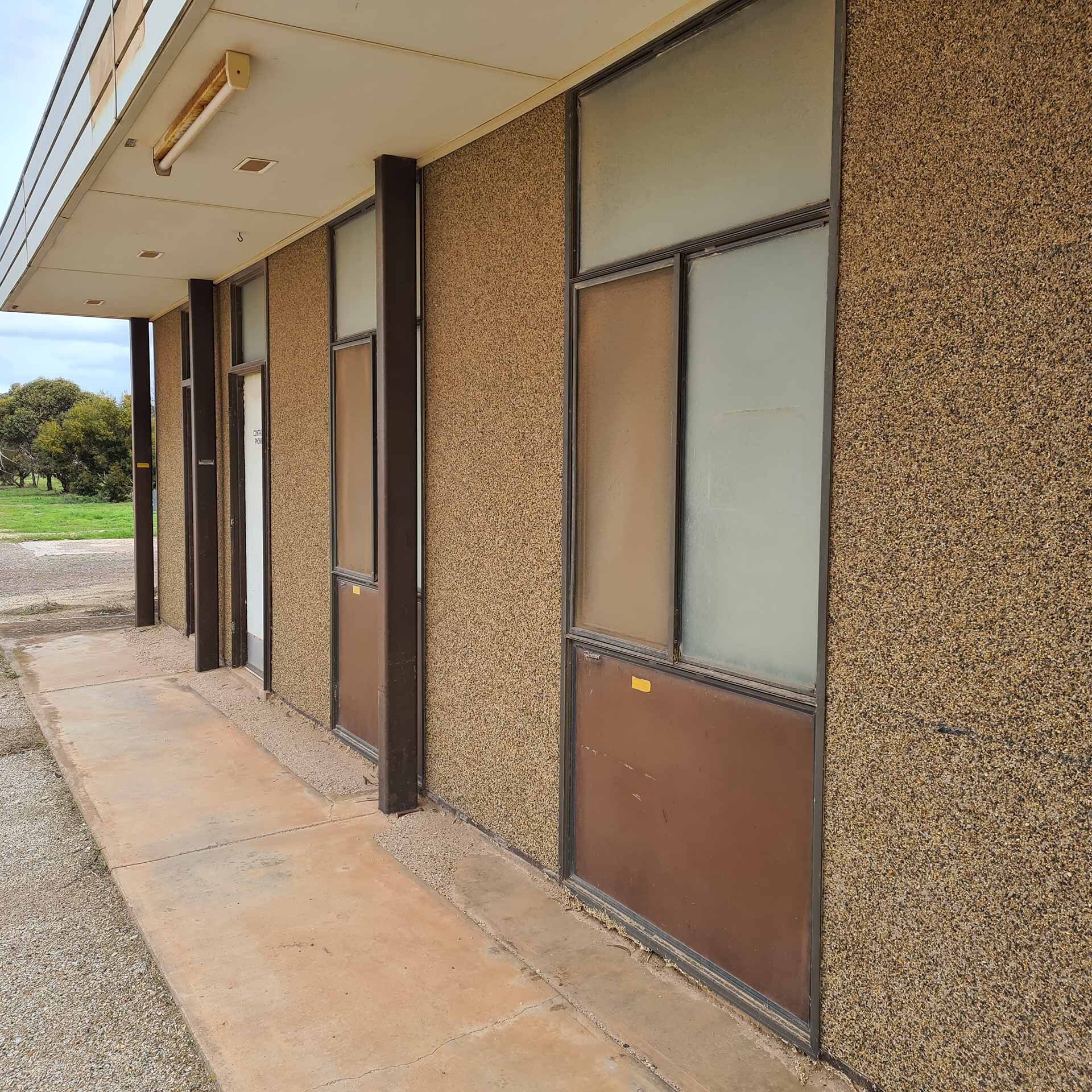 Asbestos cement aggregate finish wall panels and asbestos cement flat sheet window infills on railways building