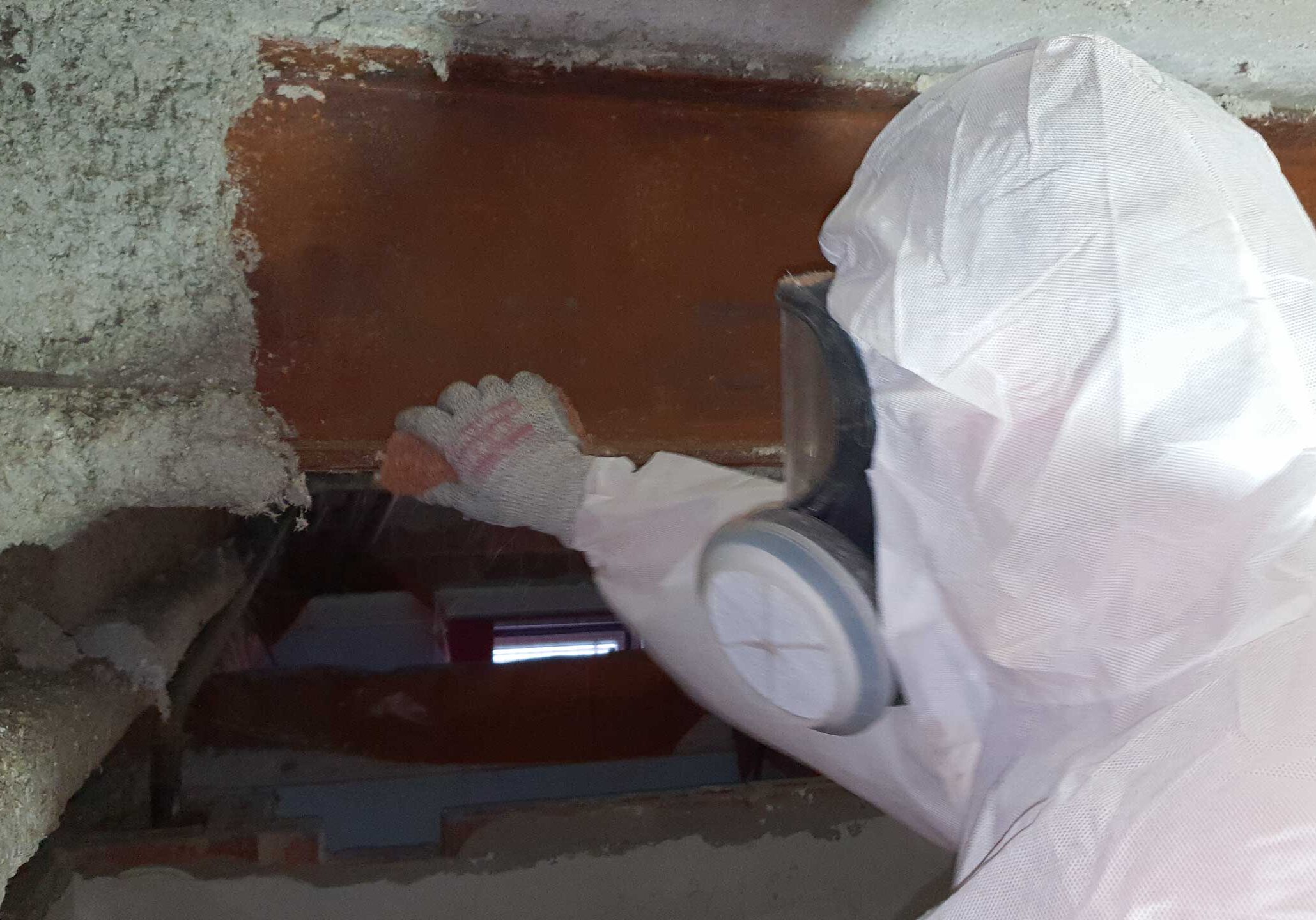 Asbestos fireproofing material on structural beams - asbestos removal in progress