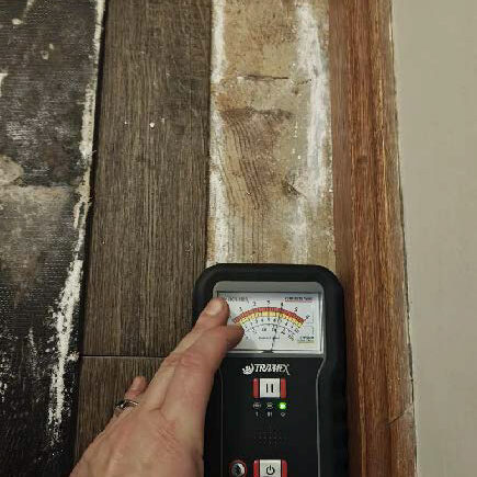 Concrete slab and back of the vinyl floor planks show impacts of moisture, salt dampness and mould. Slight warping to skirting board noted.