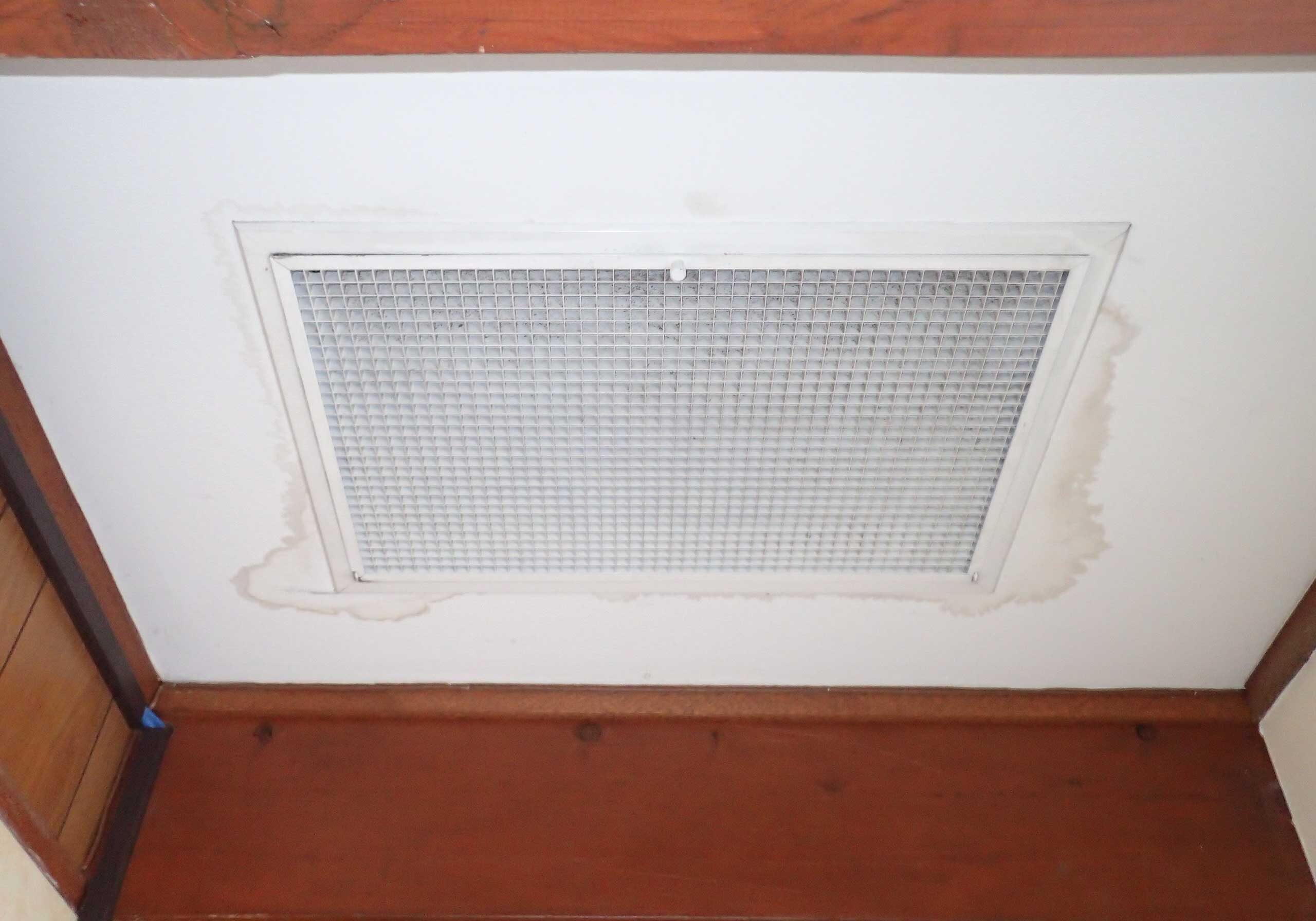 Water staining around air vent indicating failing roof flashing